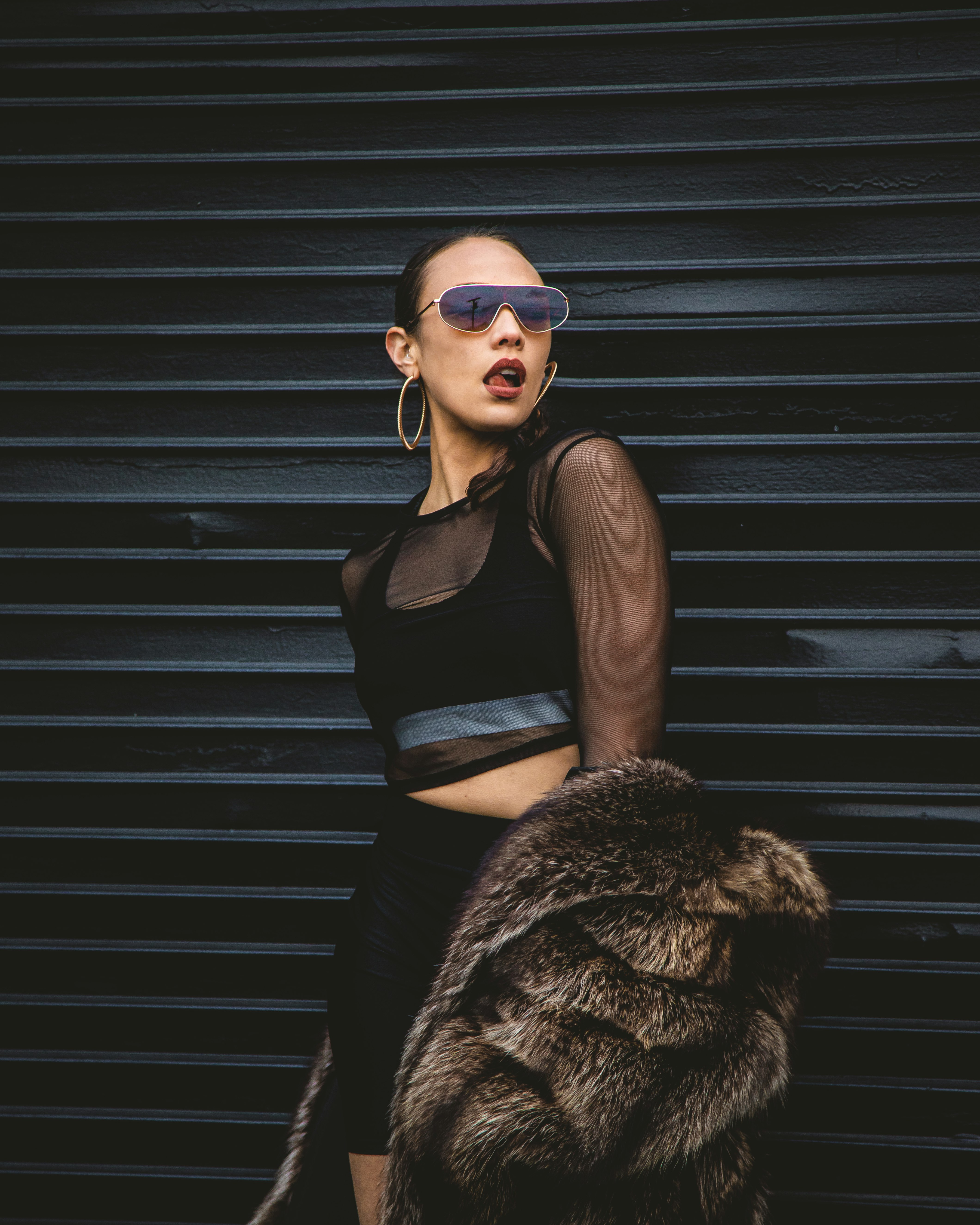 woman standing and leaning on wall